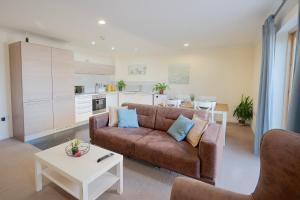 a living room with a couch and a table at Steps away from New Street Station & 2 Beds & 2 Baths Flat at City Center in Birmingham +27 photos