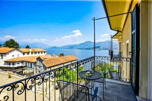 a balcony with a table and a view of the water at Antiche Cure di Ghiffa in Ghiffa