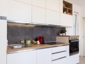 a kitchen with white cabinets and a sink at Dimora Molino Galeotto , Giardino e vista Appennino in Pavullo nel Frignano