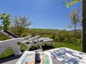 a white picnic table and a bench with a view at Dimora Molino Galeotto , Giardino e vista Appennino in Pavullo nel Frignano