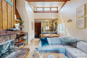 a living room with a blue couch and a table at Rustic Relaxation in Winter Park in Winter Park +35 photos