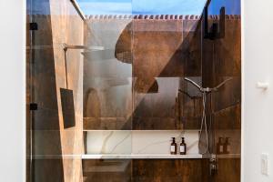 a shower with a shower curtain in a bathroom at Sand and Sky Resort Adults Only in San Pedro