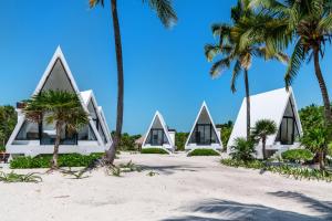 a house on the beach with palm trees at Sand and Sky Resort Adults Only in San Pedro
