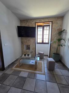 a living room with a table and a fireplace at La Casa de Iya in Las Indias