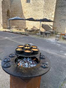 a grill with some food on top of it at Logis Hôtel Le Saint Georges in Vivonne