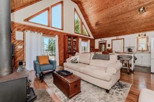 a living room with a couch and a table at Lakeview Loft A-frame Escape Tobermory in Tobermory