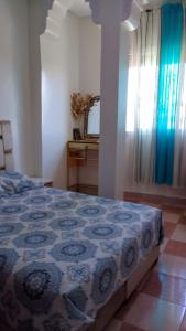 a bedroom with a bed and a dresser and a mirror at nice, sunny apartment in Meknès