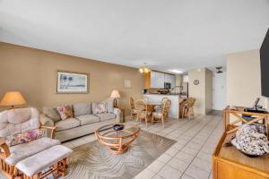 a living room with a couch and a table at Kauhale Makai 335 in Kihei