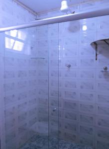 a bathroom with a shower with a glass door at Suítes Lar Doce Lar in Lavras Novas +115 photos