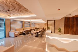 a restaurant with tables and chairs in a room at Classik Fort Inn & Suites in Cochin +48 photos