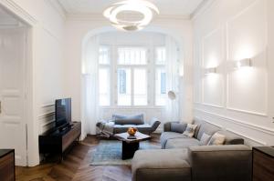a living room with a couch and a tv at Luxury Apartment by Hi5 - Best Location 3-br in Budapest