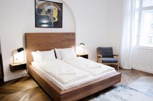a bedroom with a large bed with a wooden headboard at Luxury Apartment by Hi5 - Best Location 3-br in Budapest
