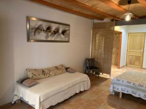 a bedroom with a bed and a chair in a room at Au bon vivre in Vivès +44 photos