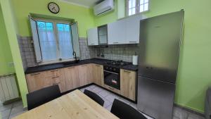 a kitchen with a table and a refrigerator and a table and chairs at Casa CAROLA in Arpino