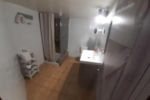 a bathroom with a sink and a mirror and a shower at Casita rural Els voladorets in Torre de Endoménech +24 photos