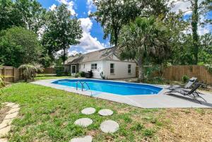 a swimming pool in the yard of a house at Modern & Tasteful Pool Home in Gainesville