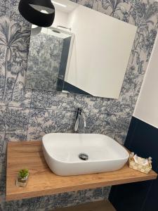a bathroom with a white sink and a mirror at AZ rooms in Noto +28 photos