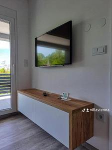 a flat screen tv on a wall in a living room at Villa Vienna in Bužim