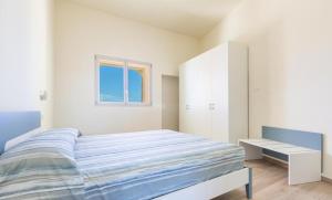Postel nebo postele na pokoji v ubytování Gemma Marina Apartments