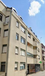 a tall building with a lot of windows at Center Apartment 1 Sisak in Sisak