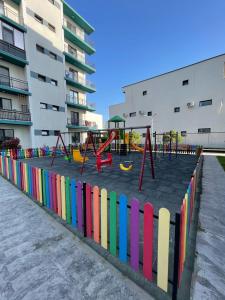a playground with a colorful fence and swings at Ayan Residence in Năvodari
