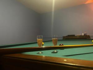 two glasses of beer on a pool table at Chateau de Maisonneuve in Leigné-les-Bois