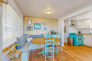 a kitchen and a living room with a table at Surftide Cottage in Rockaway Beach +13 photos