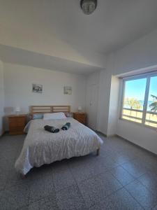 a bedroom with a bed and a large window at Beach view apartment in Cullera in Cullera