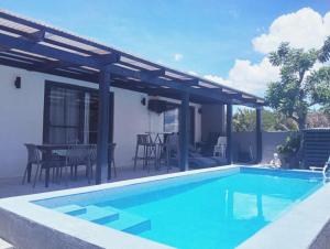 a villa with a swimming pool and a patio at Beachfront Prime Villa 2 with Private Pool in Calubcub Segundo