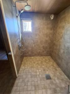 a bathroom with a shower with a window at Villa Åberg, Kuivaniemi in Ii +26 photos