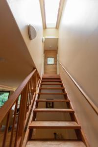 a staircase in a house with a skylight at Hidden Creek Hideaway in Roberts Creek +2 photos