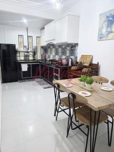 a living room with a table and a kitchen at Vantage Cottage in Jertih +11 photos