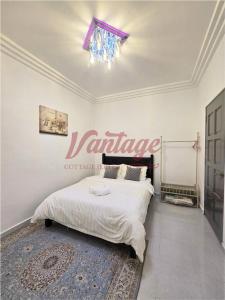 a bedroom with a bed with a sign on the wall at Vantage Cottage in Jertih
