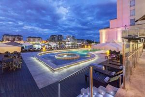 a resort with a swimming pool at night at Luxury Loft Condominiums Hotel Wyndham Nordelta in Benavídez