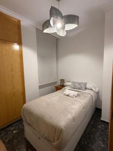 a bedroom with a bed and a ceiling fan at Antonia Medina Relax in Cogollos de Guadix