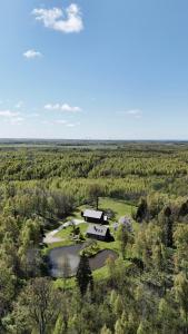 an aerial view of a house in the middle of a field at Brīvdienu māja & pirts meža vidū - Saraiķu Sanderi in Saraiķi +61 photos
