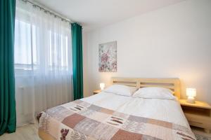 Posteľ alebo postele v izbe v ubytovaní Apartamenty Tit Kasprowicza