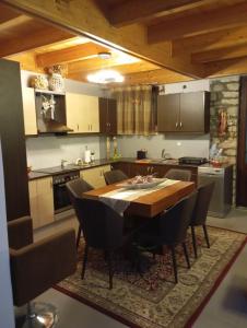 a kitchen with a wooden table and some chairs at Αρχωντικα στην Τρiχονιδα in Agrinio