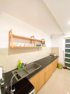 a kitchen with a sink and a counter top at Chiri Homestay in Thôn Trường Giang +43 photos