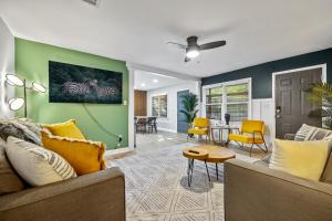 a living room with a couch and a table at East Atlanta Retreat with 2 Homes Sleeps 16 and Pet Friendly in Decatur
