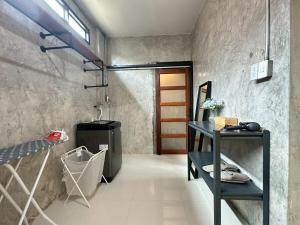 a bathroom with a sink and a table in a room at City House Don Mueang Airport Bangkok in Don Muang Airport +80 photos