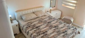 a bedroom with a bed with a large bedspread on it at Kuca za odmor Toma in Ljubuški