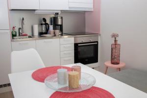 a kitchen with a table with two candles on it at Lahti City Home 1 in Lahti