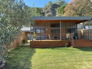 a large house with a large deck in a yard at Marmaris Tiny House Olea Gökbel in Marmaris