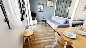 a small living room with a table and a couch at Hypercenter apartment in Vannes