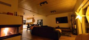 a living room with a fireplace and a couch at CasaSol Domek w Beskidach in Sól