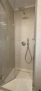 a shower with a glass door in a bathroom at Adria in Opatija