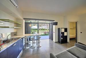 a kitchen with blue cabinets and bar stools at Camping Village Lago Maggiore in Dormelletto