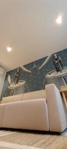 a living room with a couch and two sculptures on the wall at Adria in Opatija