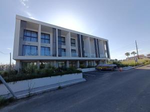 a building with a car parked in a parking lot at kallithea maisonette in Kallithea Halkidikis